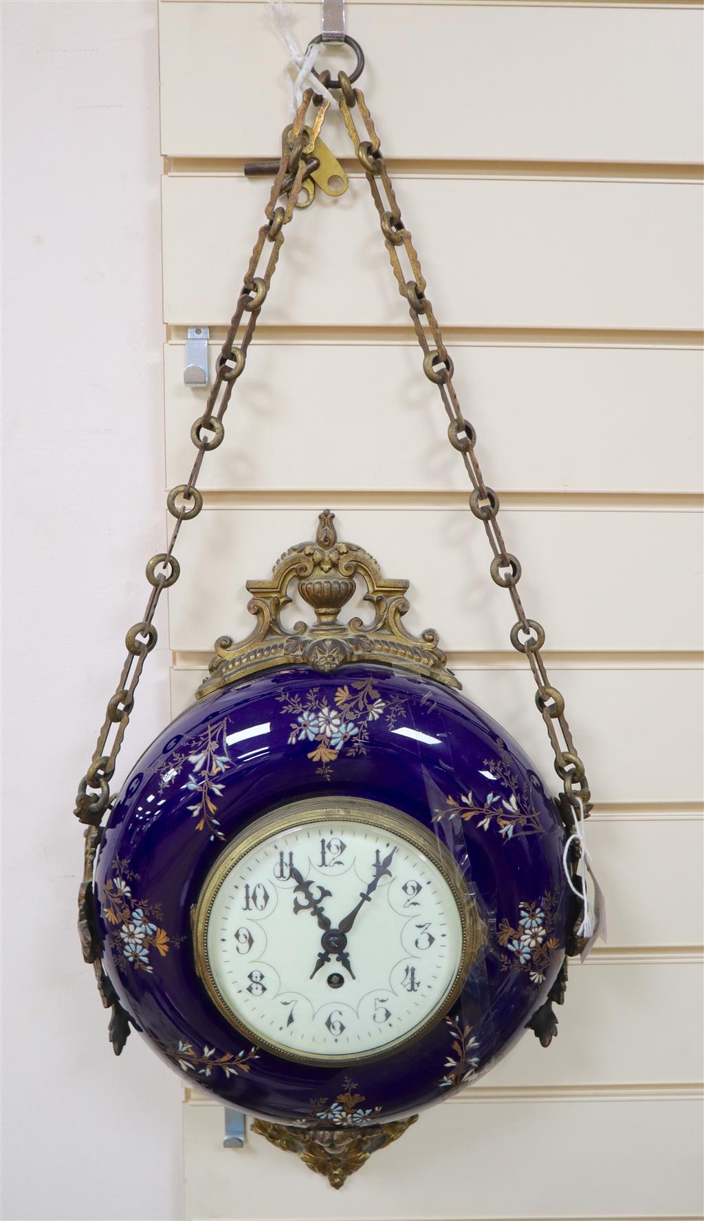 A late 19th century French wall clock, with floral-decorated blue ceramic frame, circular enamelled dial and gilt metal mounts